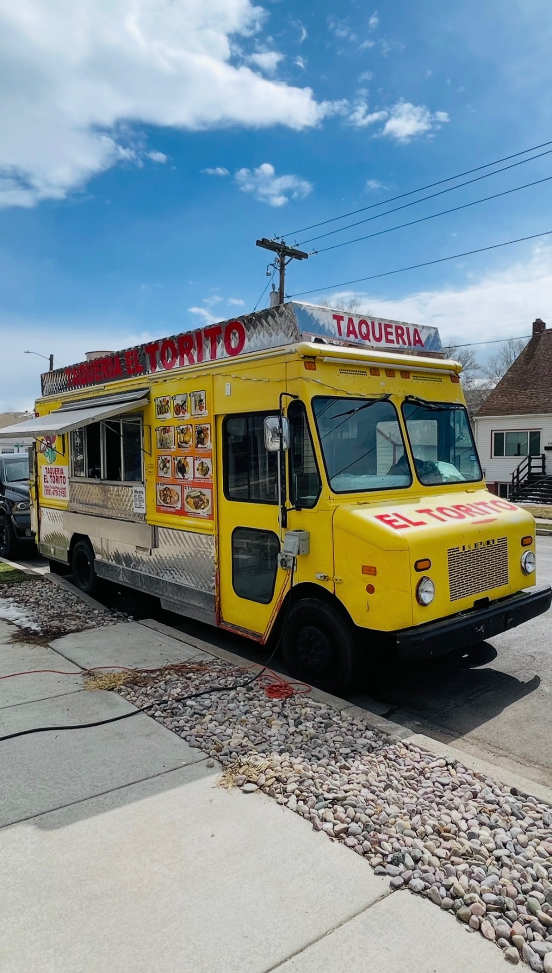 The yellow Taquería El Torito food truck parked on a sunny Pocatello street